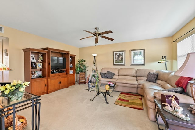 living room with ceiling fan and carpet