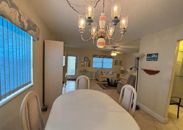 dining room with ceiling fan with notable chandelier and light tile patterned floors