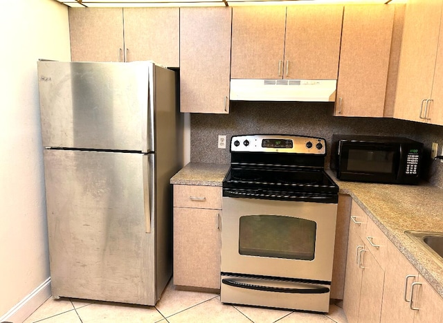 kitchen featuring stainless steel appliances, tasteful backsplash, light tile patterned floors, and light brown cabinets