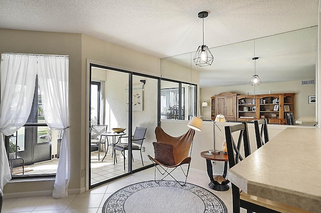 tiled dining room with a textured ceiling