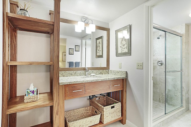 bathroom with an enclosed shower, vanity, and a notable chandelier