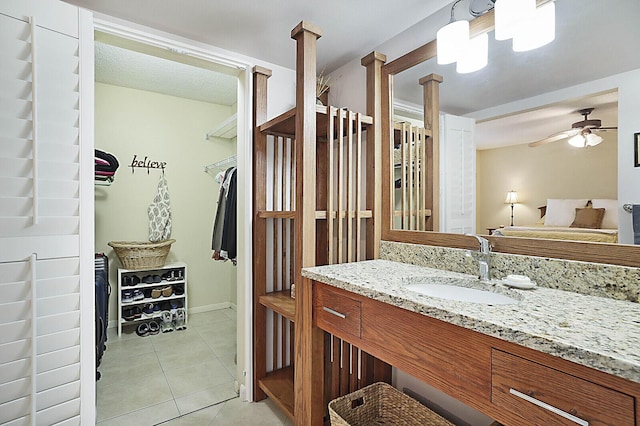 bathroom with ceiling fan, tile patterned floors, and vanity