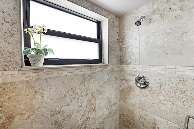 bathroom with tiled shower