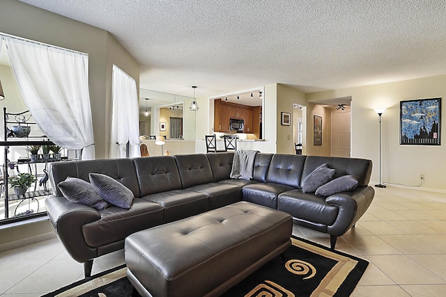 tiled living room featuring a textured ceiling