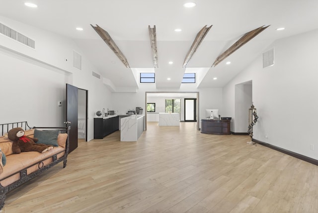 living room featuring high vaulted ceiling, beam ceiling, and light hardwood / wood-style floors