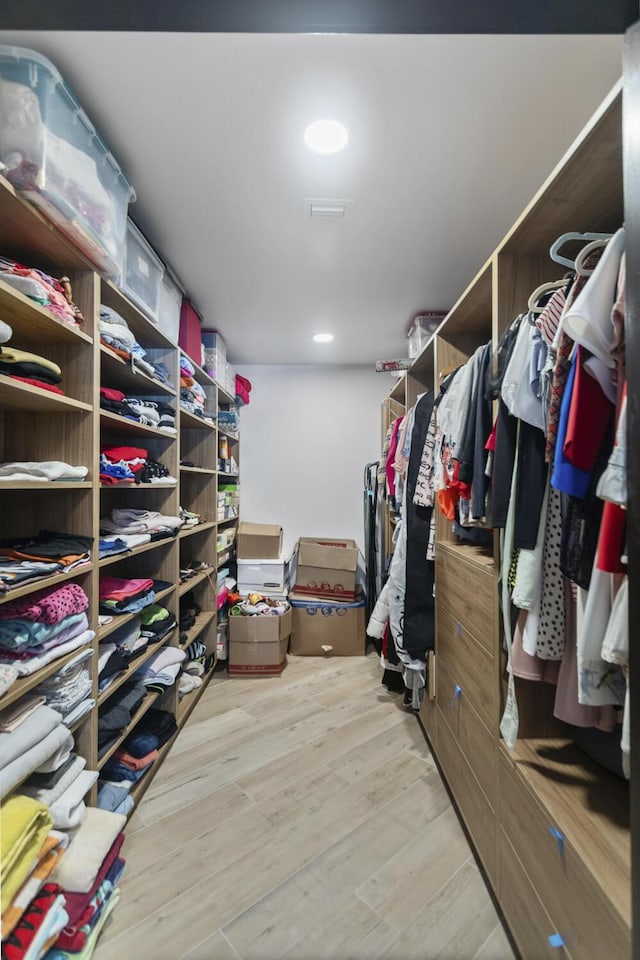 spacious closet with light hardwood / wood-style floors