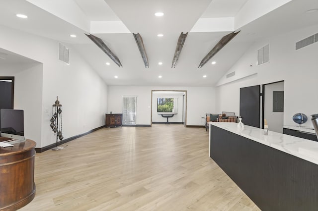 interior space featuring beamed ceiling, high vaulted ceiling, and light hardwood / wood-style flooring