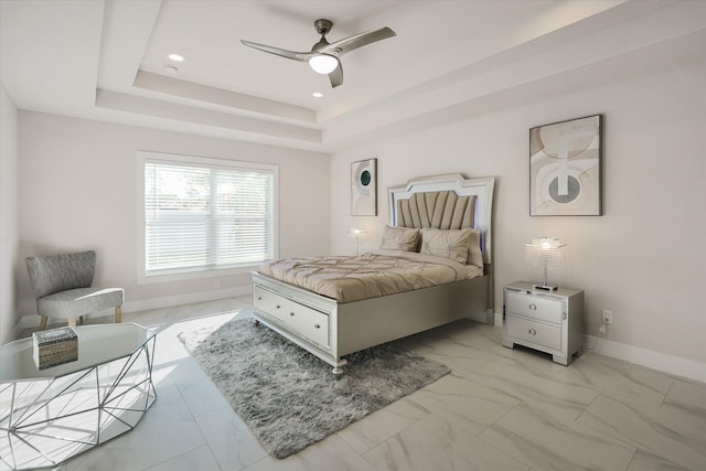 bedroom featuring a tray ceiling and ceiling fan