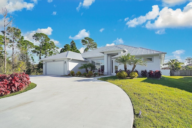 view of front of house with a garage and a front yard