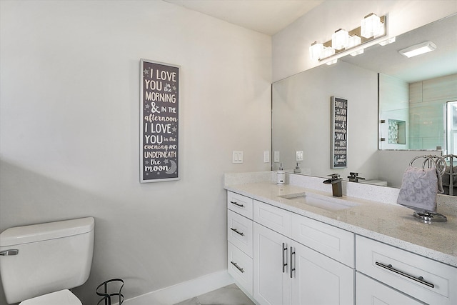 bathroom with vanity, tile patterned floors, and toilet