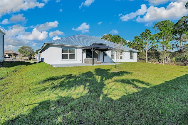 rear view of property featuring a gazebo, a yard, and a patio area