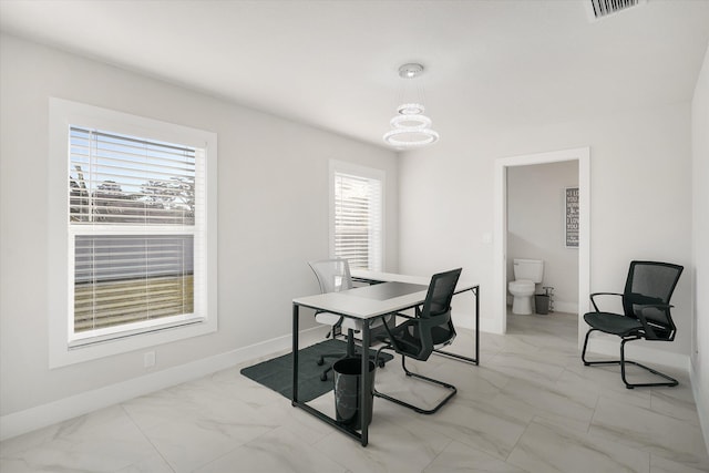 office area featuring a chandelier