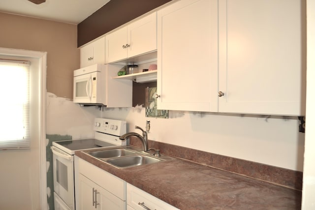 kitchen with white cabinetry, white appliances, and sink