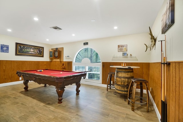 playroom with light hardwood / wood-style flooring, pool table, and wooden walls