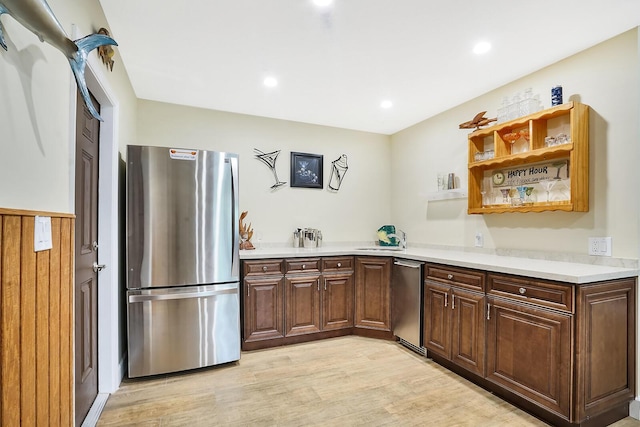 kitchen featuring stainless steel refrigerator and light hardwood / wood-style flooring