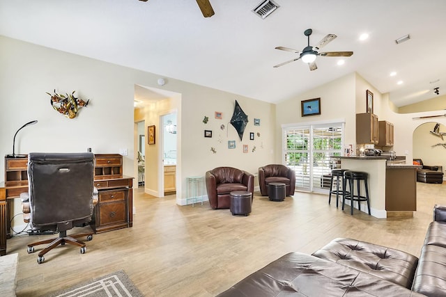 living room featuring vaulted ceiling, ceiling fan, and light hardwood / wood-style floors