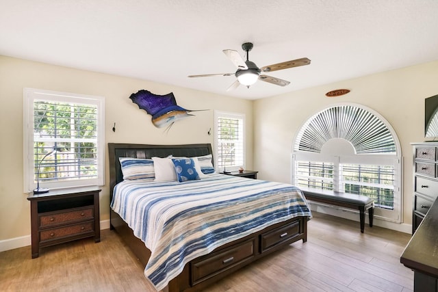 bedroom with ceiling fan and light wood-type flooring