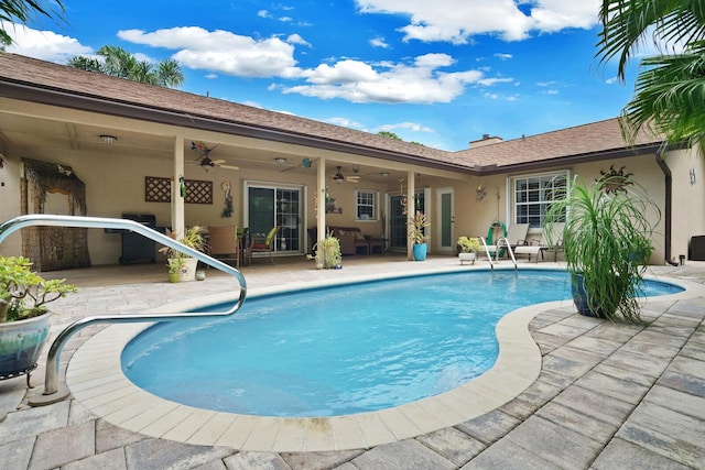 view of swimming pool with a patio and ceiling fan