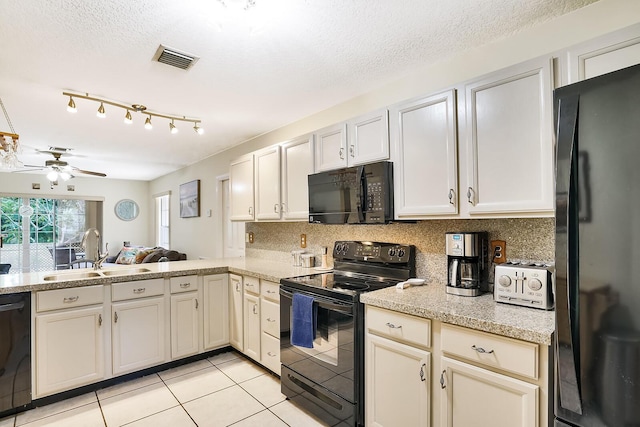 kitchen with sink, tasteful backsplash, light tile patterned floors, kitchen peninsula, and black appliances