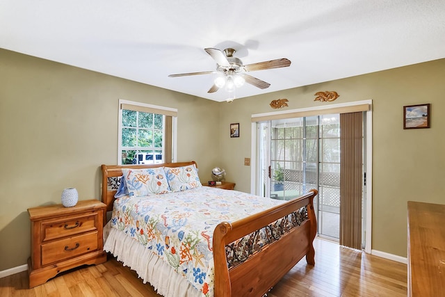 bedroom with hardwood / wood-style floors, access to outside, and ceiling fan