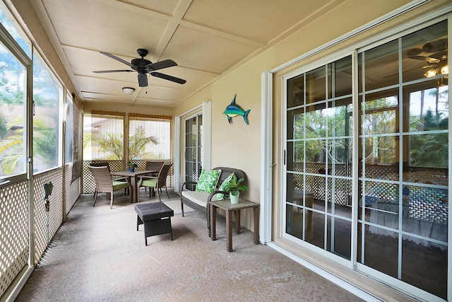 sunroom / solarium featuring ceiling fan