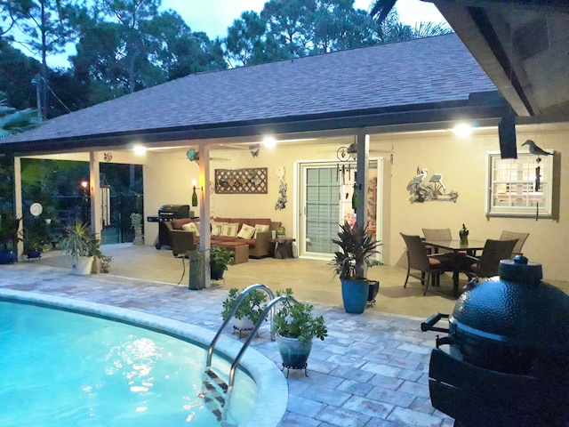 rear view of house with a patio and outdoor lounge area