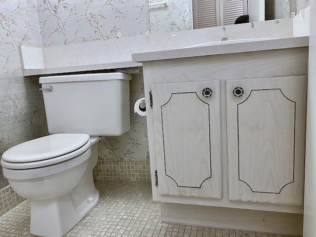 bathroom featuring vanity, tile patterned flooring, and toilet