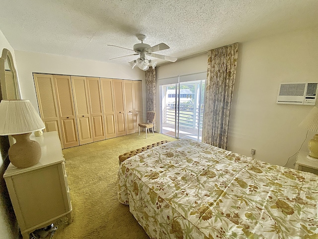 carpeted bedroom featuring ceiling fan, a wall unit AC, and a textured ceiling