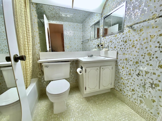 full bathroom with vanity, shower / bath combo, and toilet