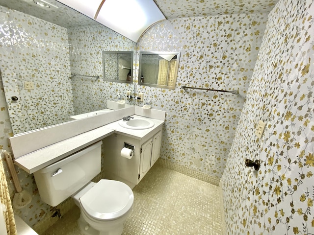 bathroom with tile patterned floors, vanity, and toilet