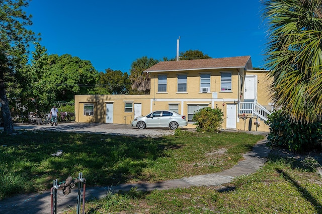 back of property with a lawn