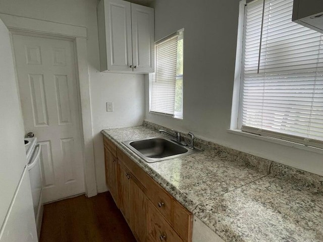 kitchen with white cabinetry, white electric range oven, and sink