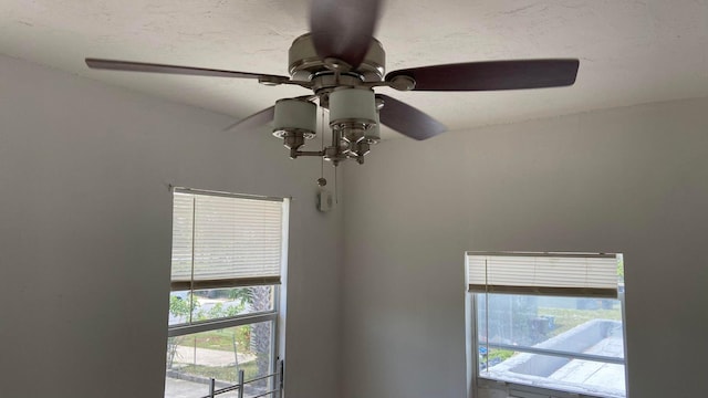 interior details featuring a textured ceiling and ceiling fan