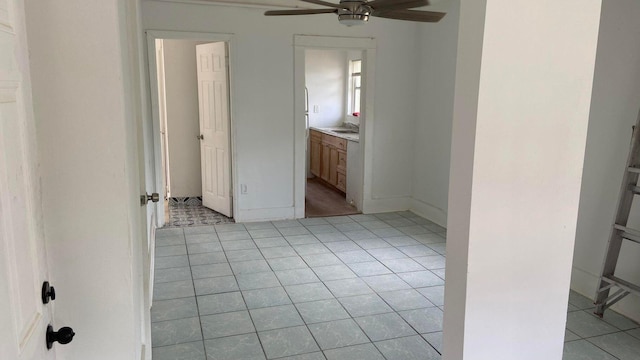 unfurnished room with sink, ceiling fan, and light tile patterned flooring