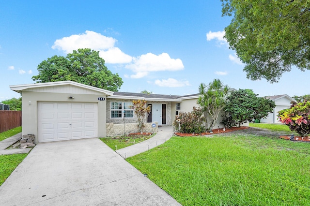 single story home featuring a garage and a front lawn