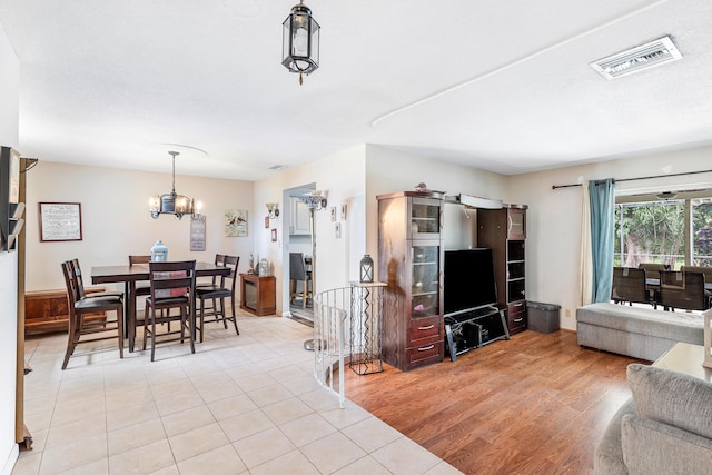 living room with a notable chandelier and light hardwood / wood-style floors