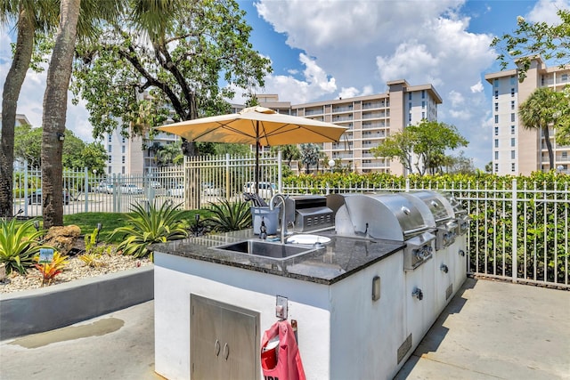 view of patio / terrace featuring area for grilling, sink, and grilling area