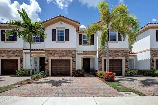 mediterranean / spanish-style house with a garage