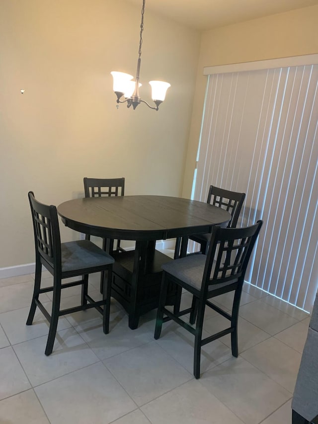 dining space featuring tile patterned flooring and a chandelier