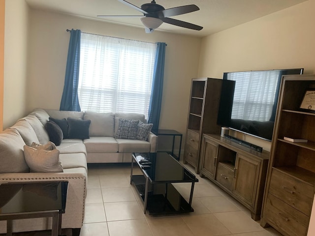 living room featuring light tile patterned floors and ceiling fan