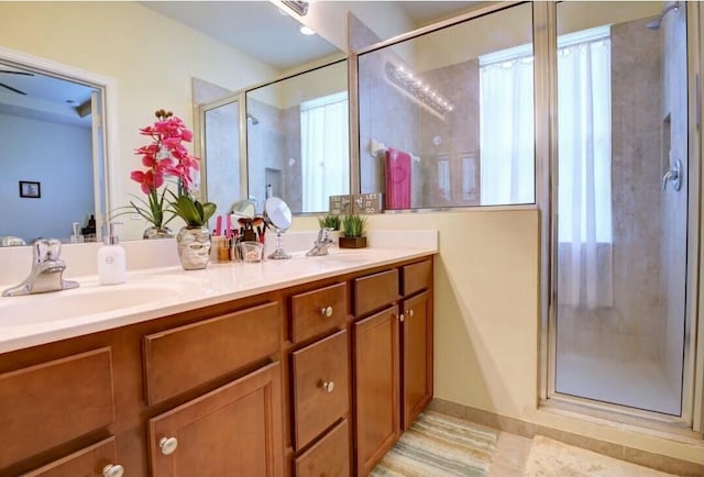 bathroom featuring walk in shower and vanity