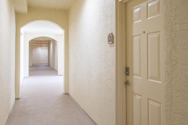 hallway with light colored carpet