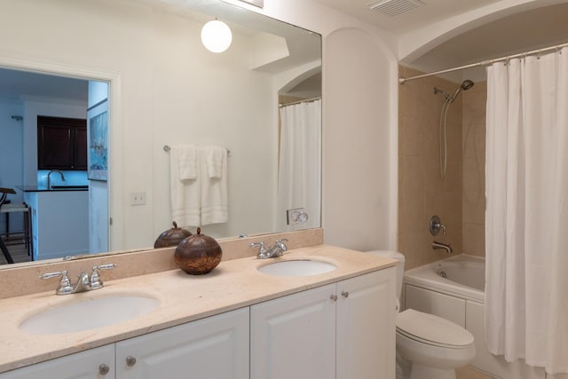 full bathroom featuring vanity, toilet, and shower / bath combo with shower curtain