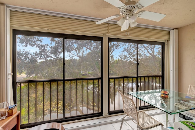 unfurnished sunroom featuring ceiling fan