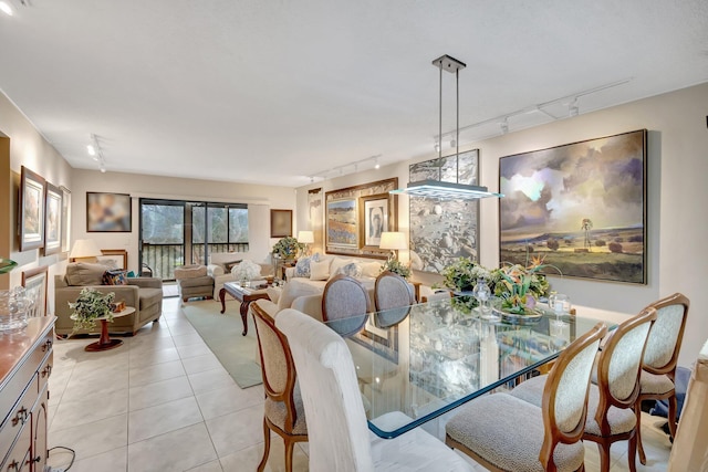 dining area featuring rail lighting and light tile patterned flooring