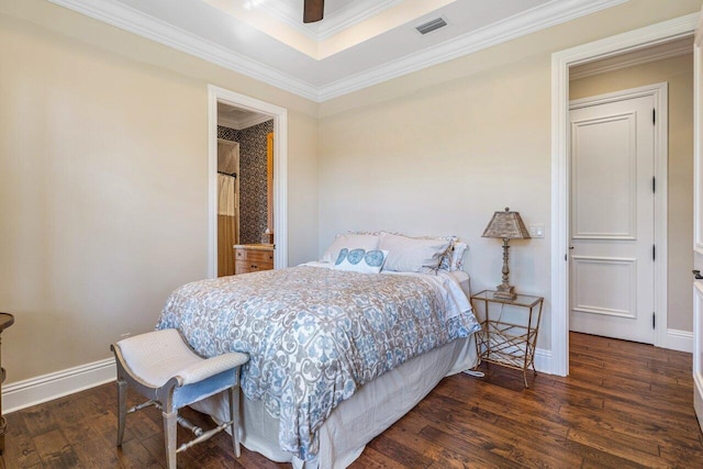 bedroom with crown molding and dark hardwood / wood-style floors