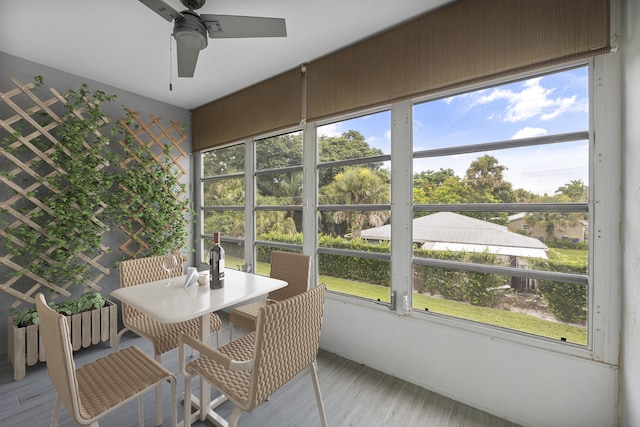 sunroom featuring ceiling fan