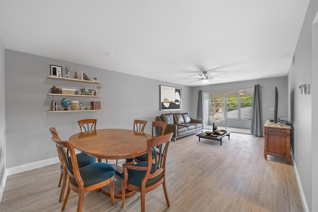 dining area with ceiling fan and light hardwood / wood-style floors