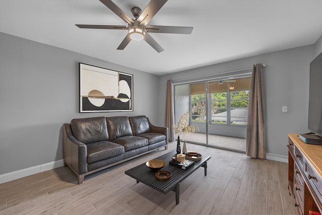 living room with ceiling fan and light hardwood / wood-style floors