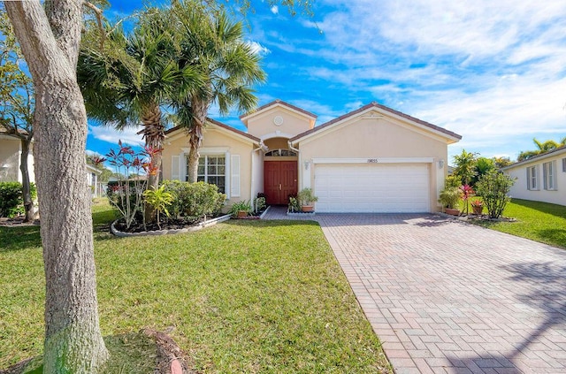 ranch-style home with a garage and a front lawn